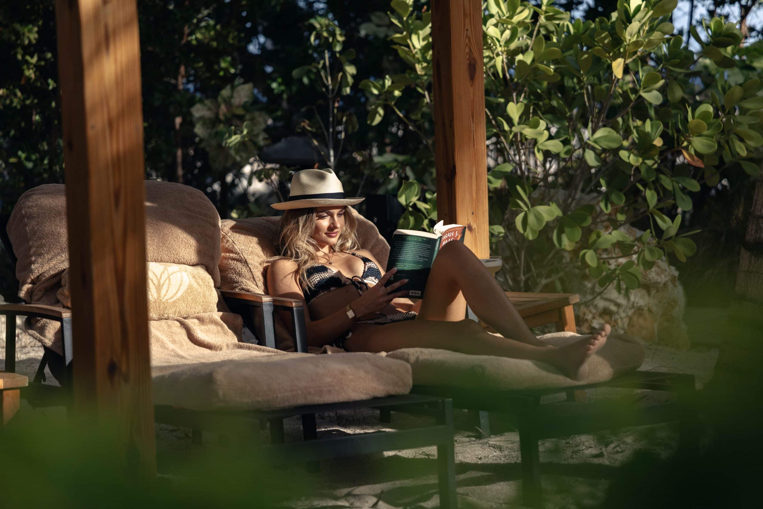 Relaxing and reading by the sea at Bida Island luxury retreat in Curaçao