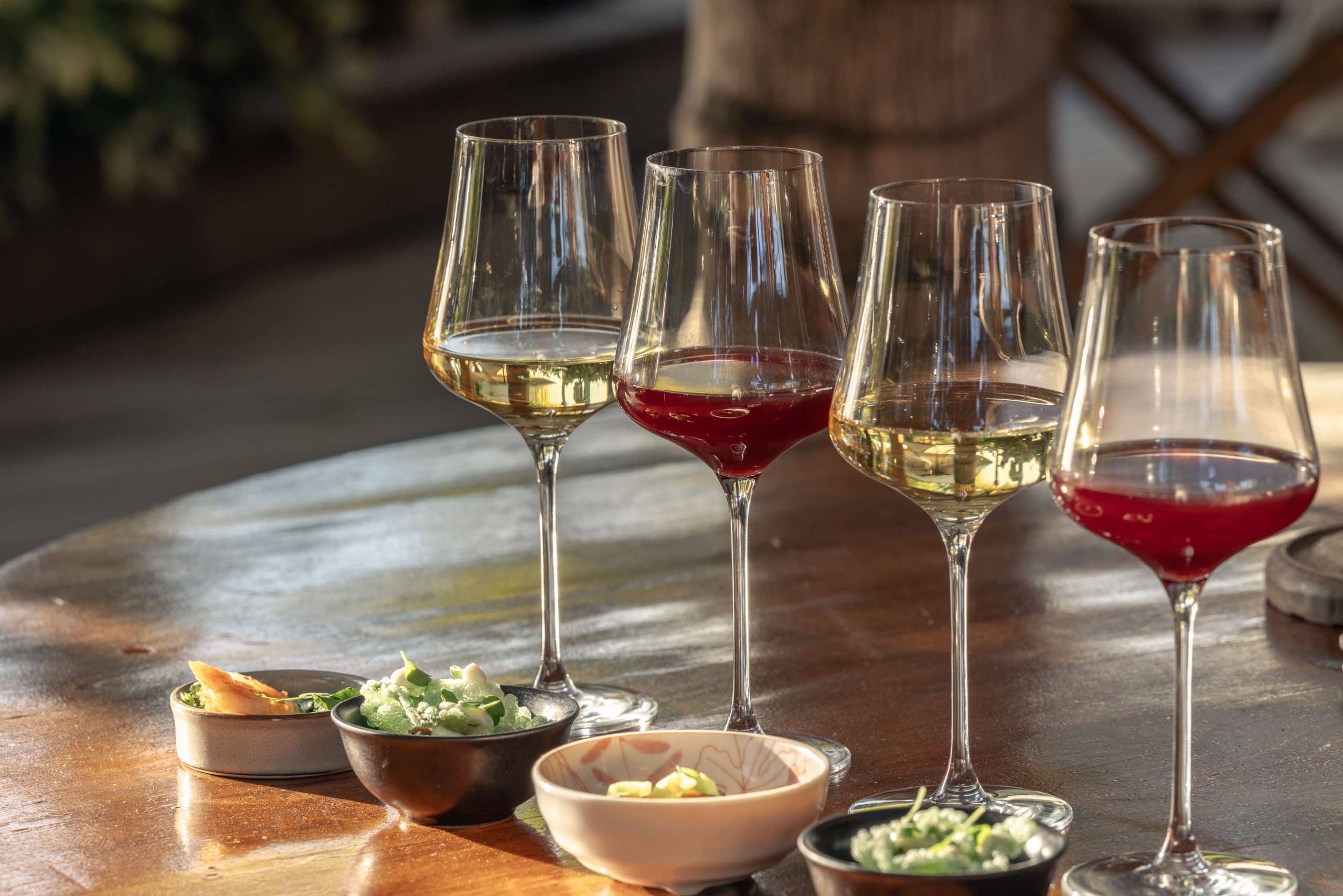 Four exceptional wines, served blind and thoughtfully paired with curated bites.